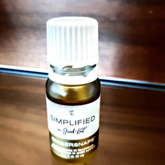 Essential oil bottle with white cap, brown glass, and brand label "Simplified