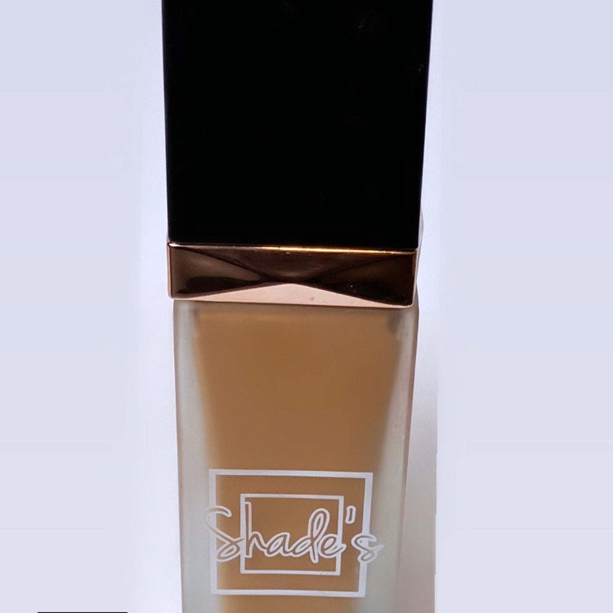 Front view of Shade-Perfect Foundation compact showing sleek black case with gold trim and open mirror