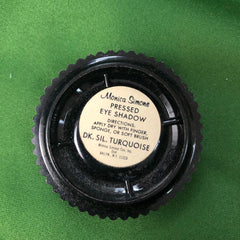 Pressed eye shadow, black plastic compact with label, Monica Simone brand, turquoise color