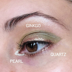 Side view of Eye Potion Quartz Shadow pot showing shimmering taupe powder and sleek black compact