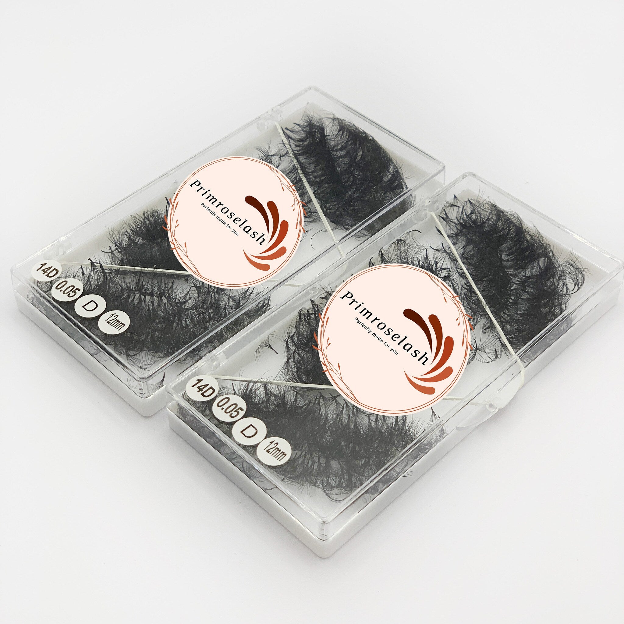 Eyelashes, black synthetic fibers in clear plastic case, Primroselash brand name visible, cosmetic product