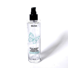 Facial cleanser bottle with black pump, clear glass, and teal butterfly graphic.