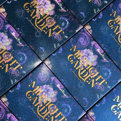 Side view of Midnight Garden Eyeshadow Palette showing sleek black compact with floral design and open pans
