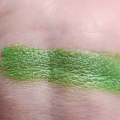 Close-up of vibrant green shimmer eyeshadow palette with smooth, blendable powder texture