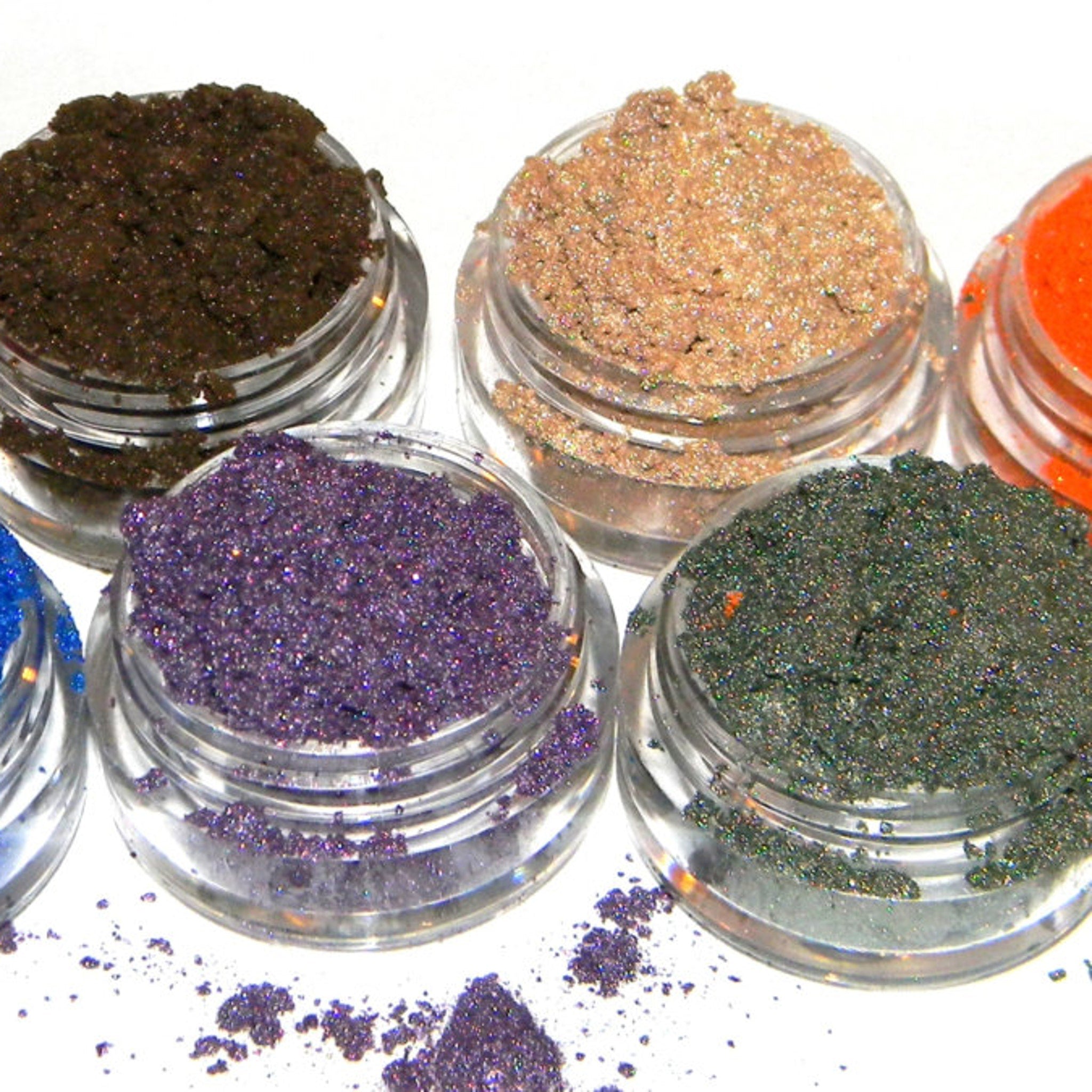 Close-up of shimmery frosty plum purple eyeshadow being applied to eyelid with brush
