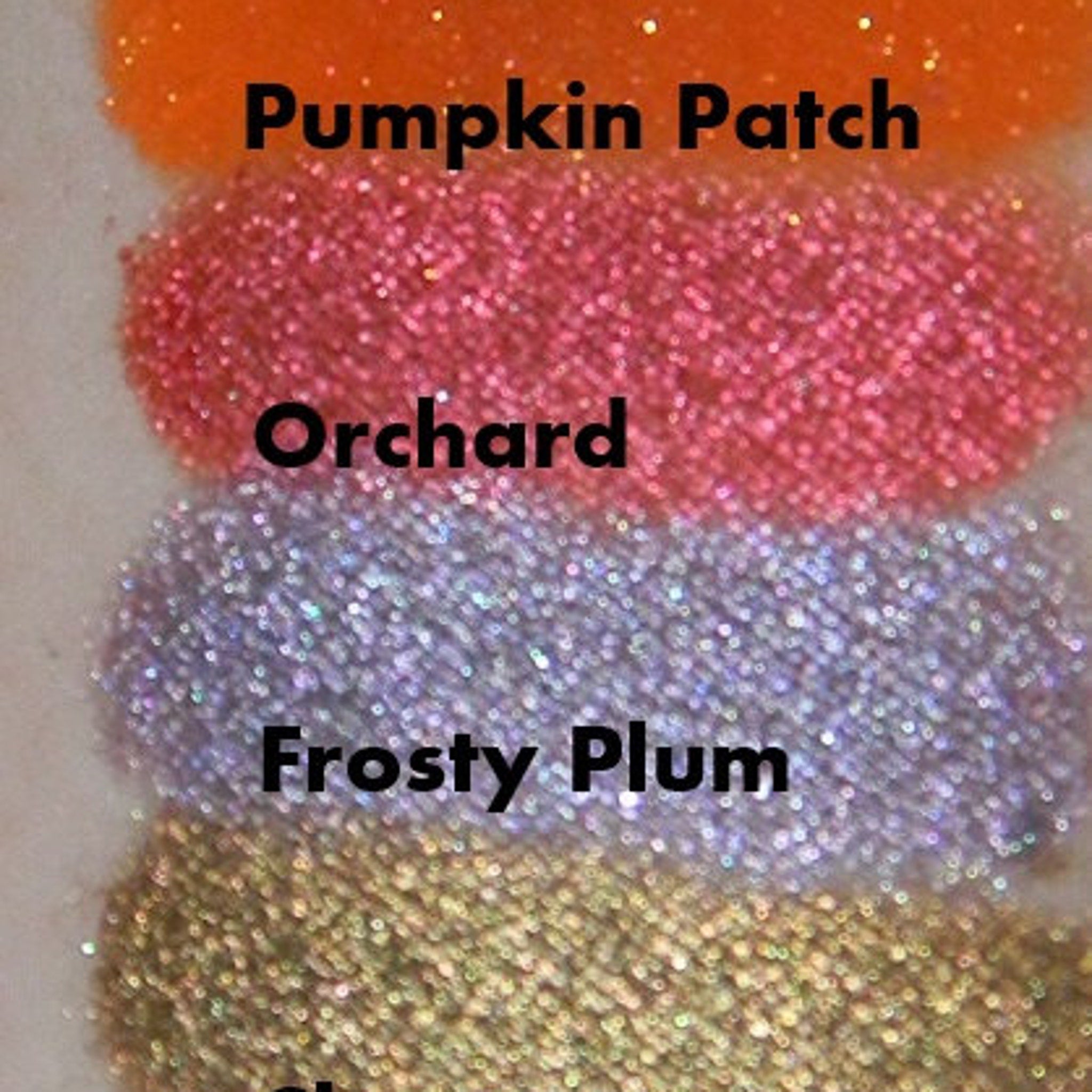 Frosty plum purple eyeshadow pan in sleek black compact with silver detailing, open to show shimmery texture