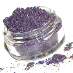 Close-up of shimmery frosty plum purple eyeshadow pan showing metallic sheen and smooth texture