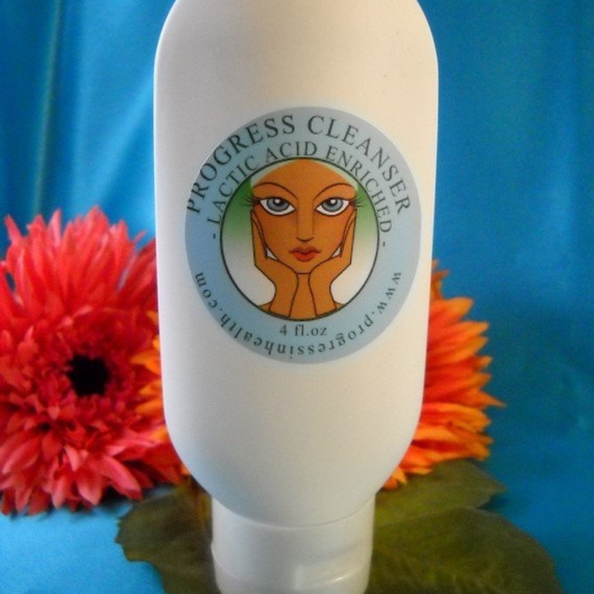 Cleanser bottle, white plastic, Progress Cleanser label, orange and red flowers in background