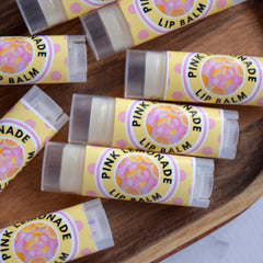 Lip balm tubes with yellow and pink labels, clear plastic, and pink polka dots, labeled Pink Lemonade