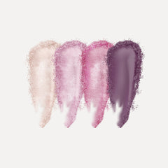 Close-up of fingertips applying shimmering taupe eye shadow to eyelid with soft blending brush