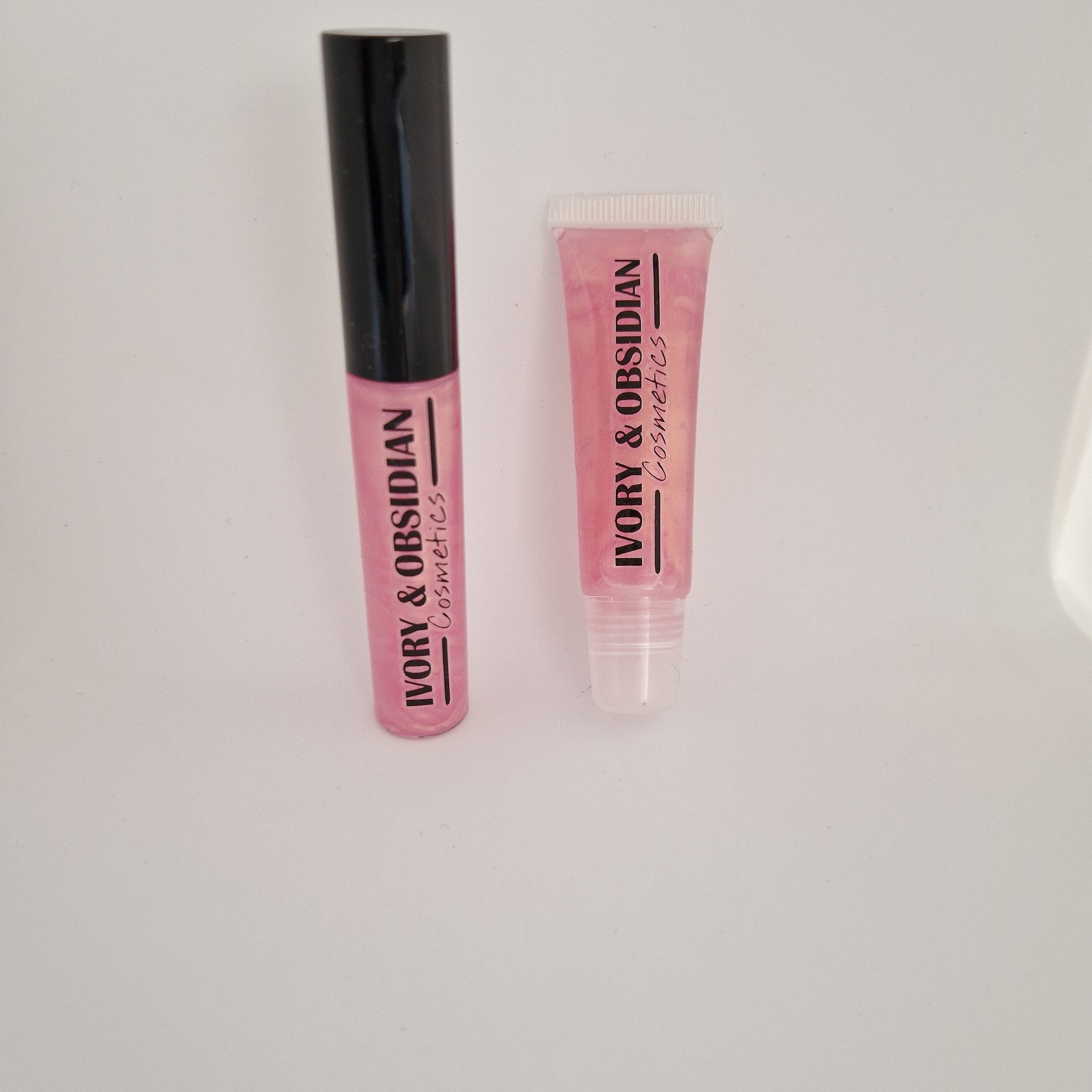 Lip gloss tubes, pink with black cap, and clear tube, Ivory & Obsidian Cosmetics branding