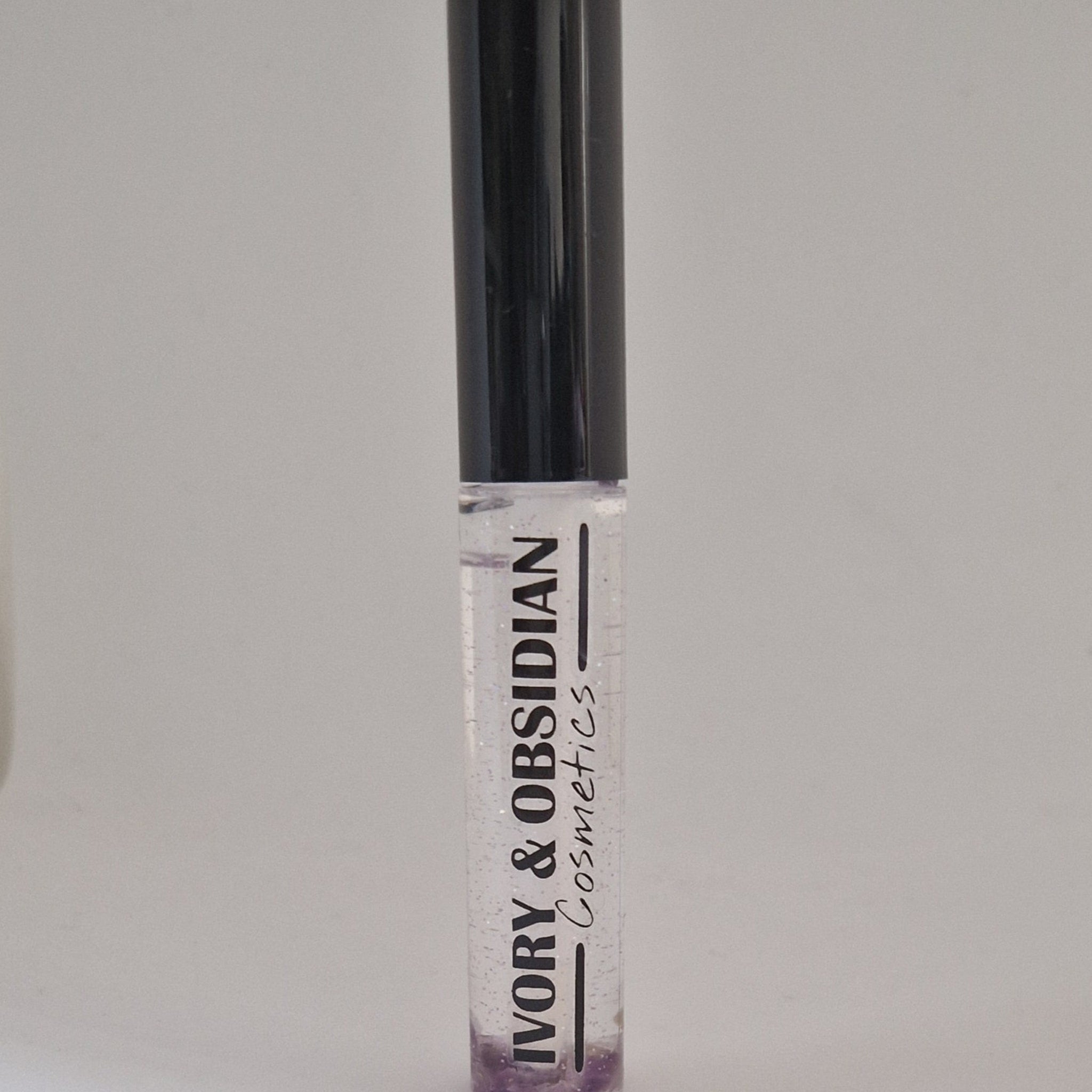 Lip gloss tube with black cap, clear gloss, and Ivory & Obsidian Cosmetics text