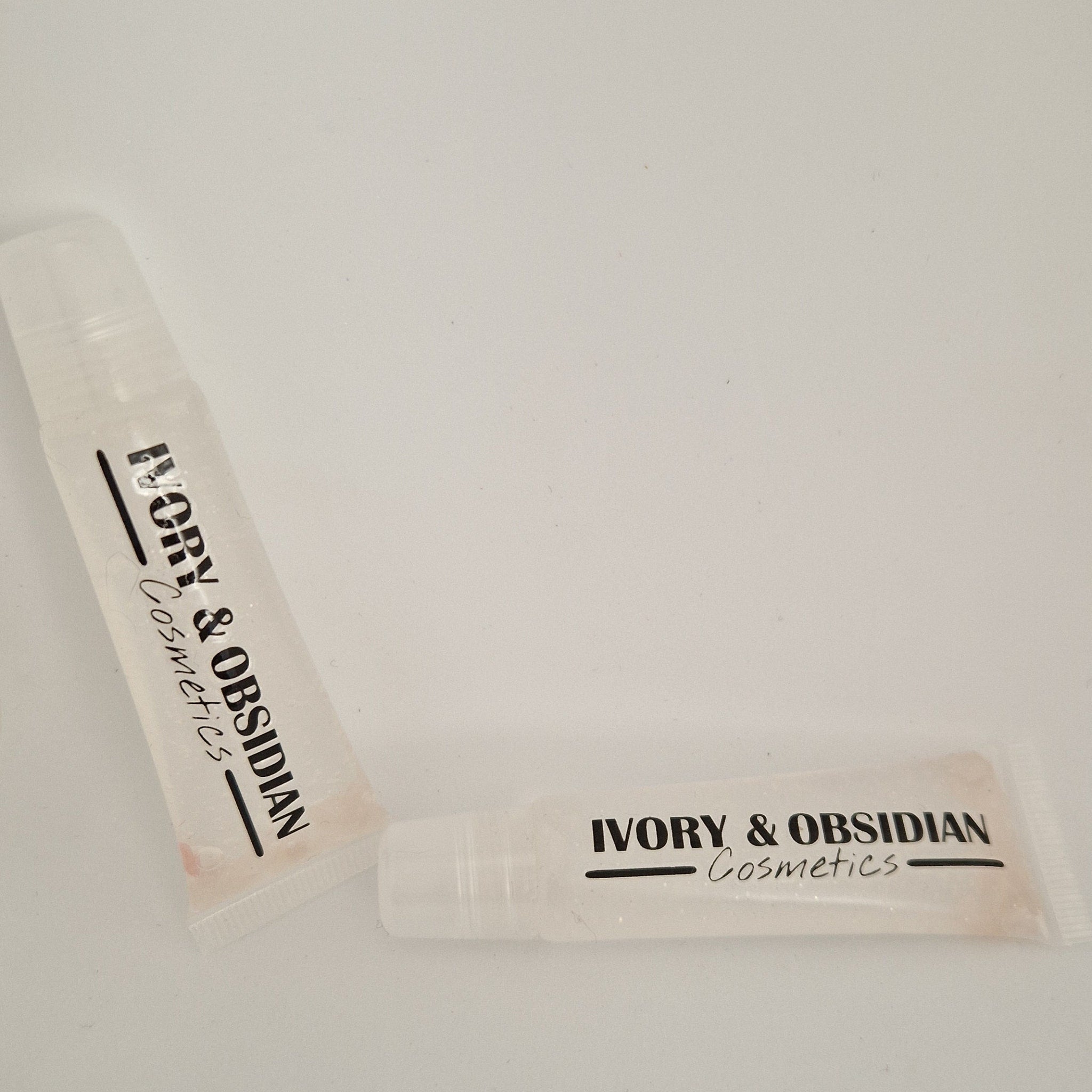 Lip gloss tubes, clear plastic, Ivory & Obsidian Cosmetics, pink tint inside
