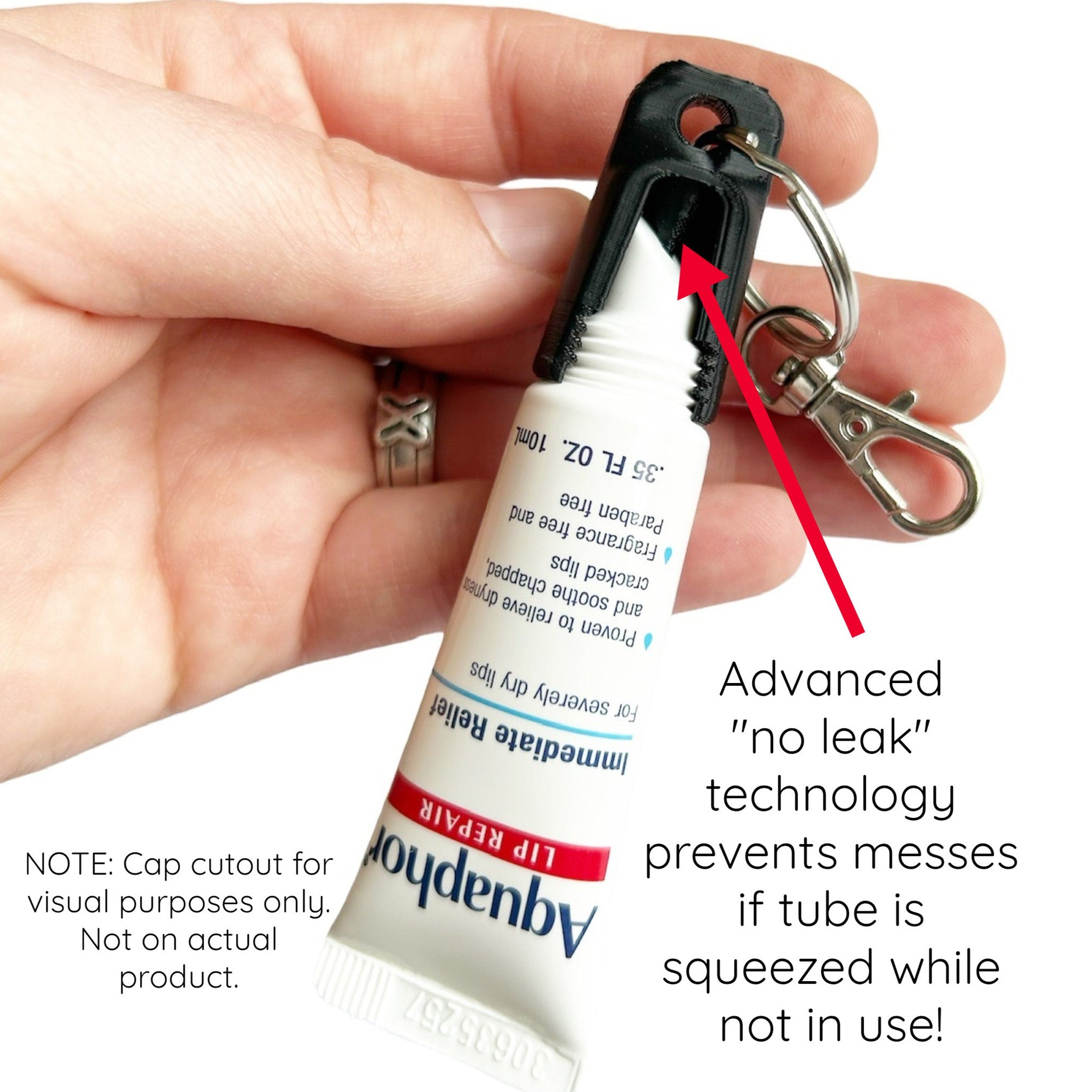 Aquaphor lip repair tube, white and blue tube with black holder, held in hand with key ring attached