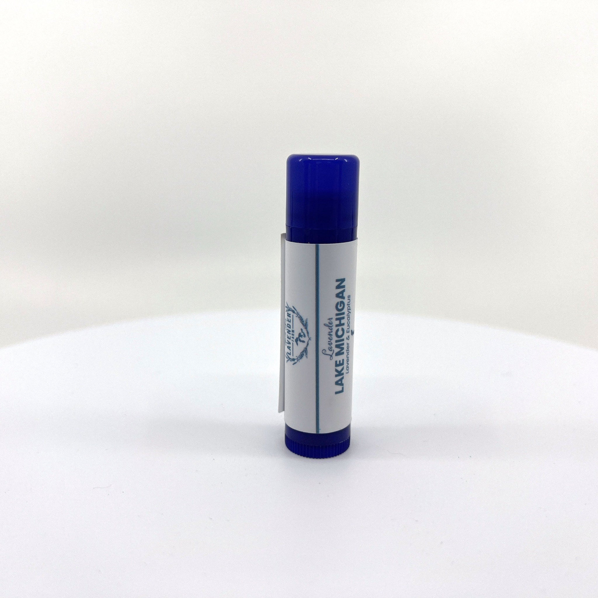 Lip balm tube with blue cap, white label, and text "Lake Michigan