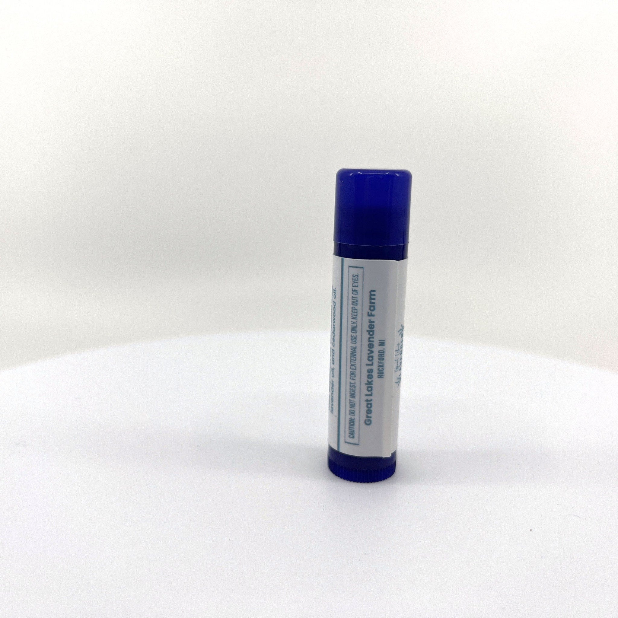 Lip balm tube with blue cap and white label, Great Lakes Lavender Farm text visible
