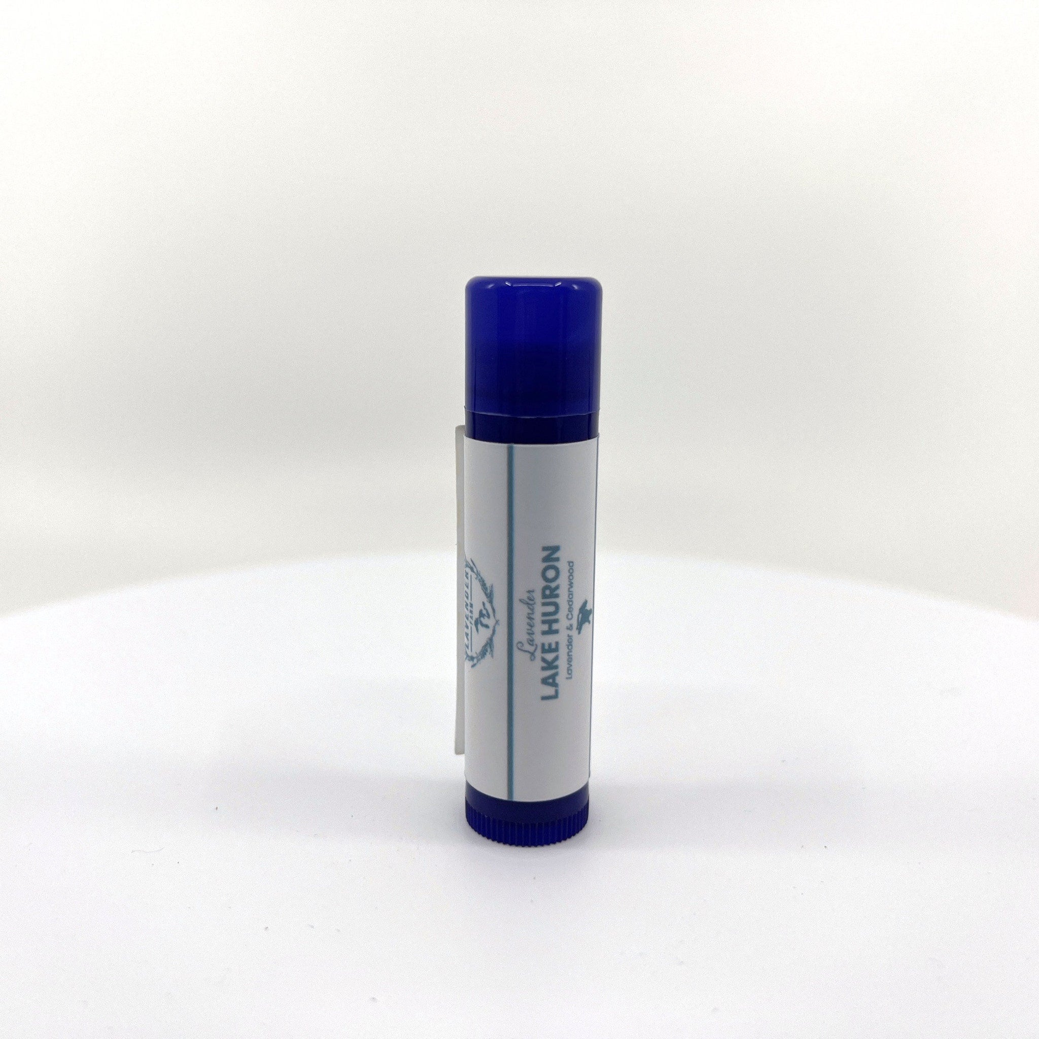 Lip balm tube with blue cap, white label, and brand text "Lake Huron