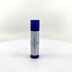 Lip balm stick with blue cap, white label, and brand text "Lake Huron" visible