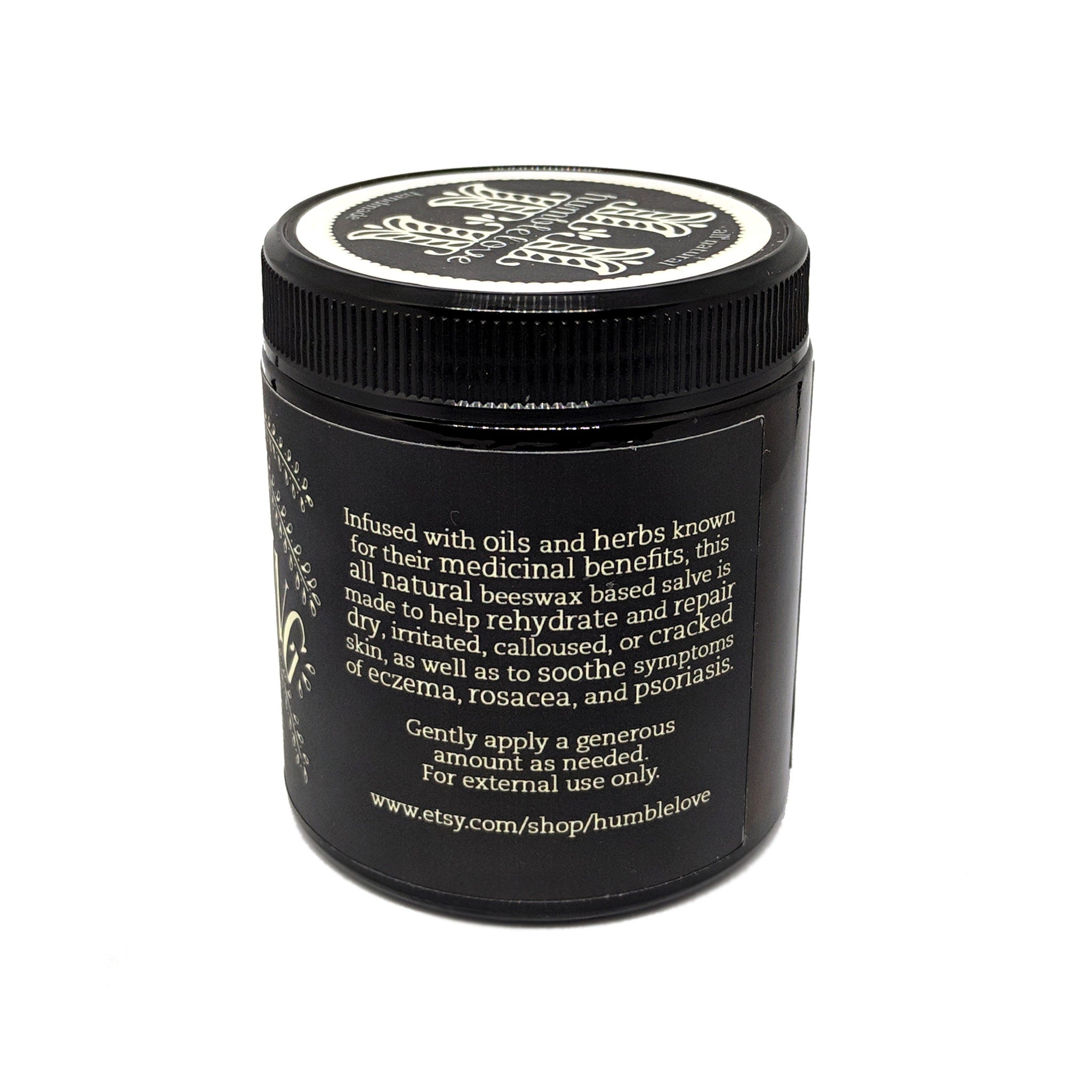 Side view of amber glass jar with all-natural herbal salve, showcasing creamy texture and minimalist label design