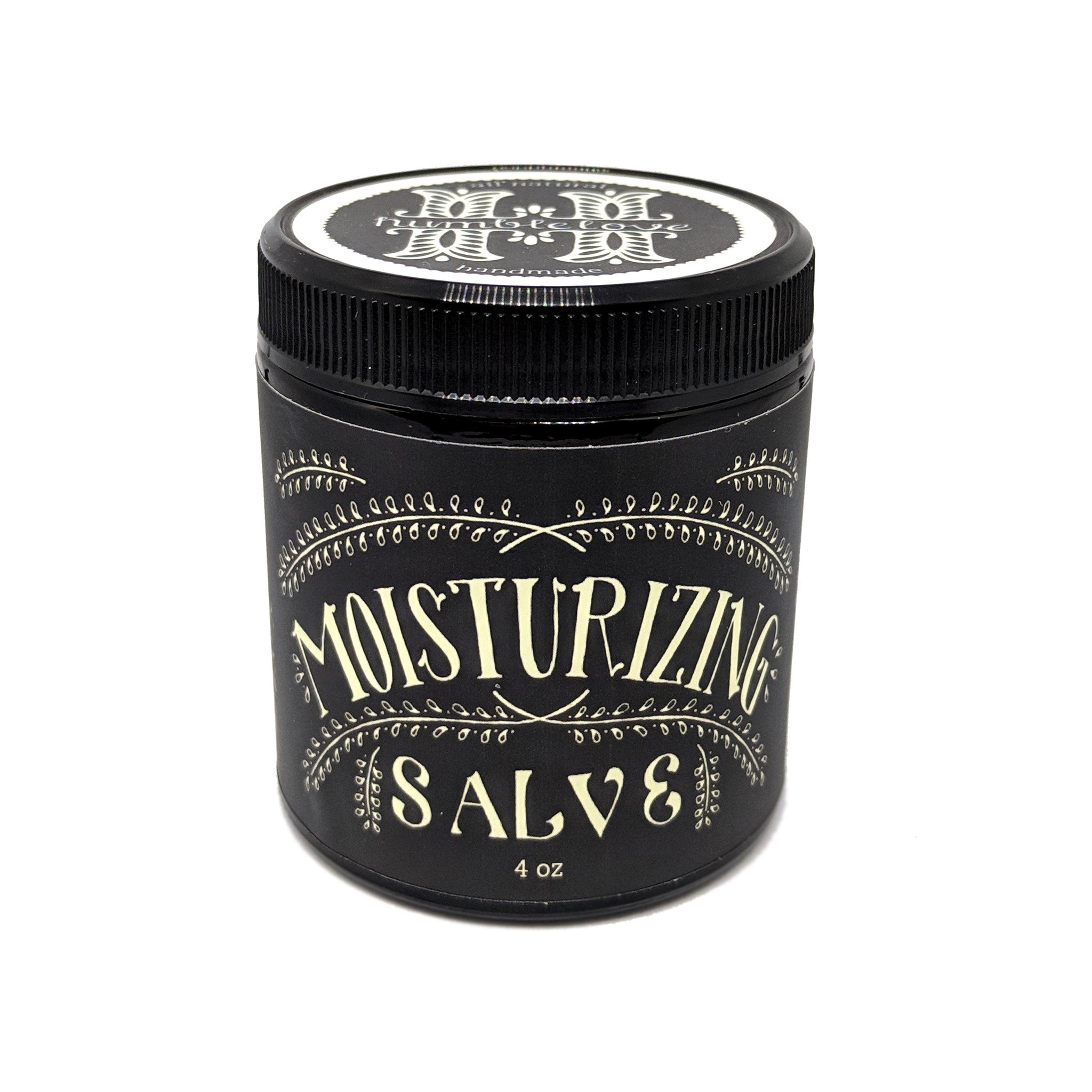 Close-up of golden herbal salve in glass jar with natural texture and visible plant extracts