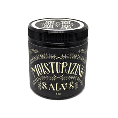 Close-up of golden herbal salve in glass jar with natural texture and visible plant extracts