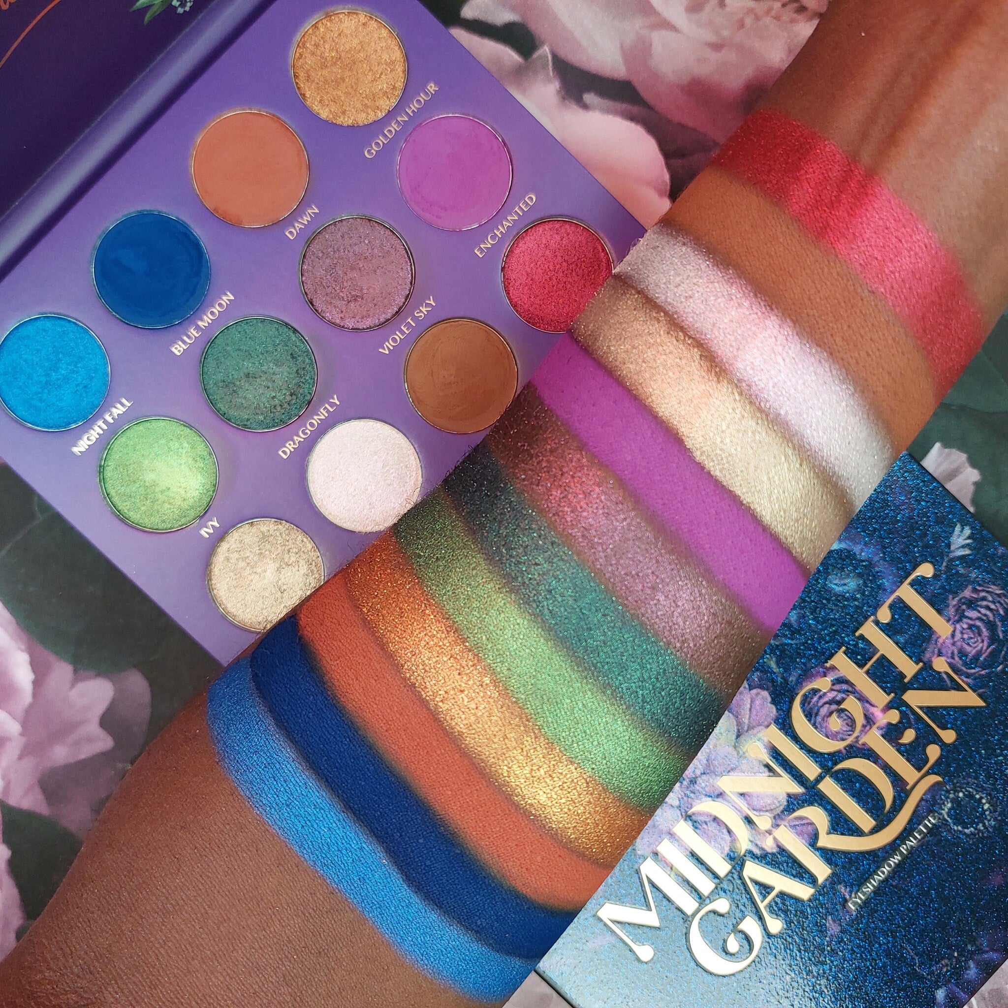 Woman applying deep plum eyeshadow with a fluffy brush from the Midnight Garden palette