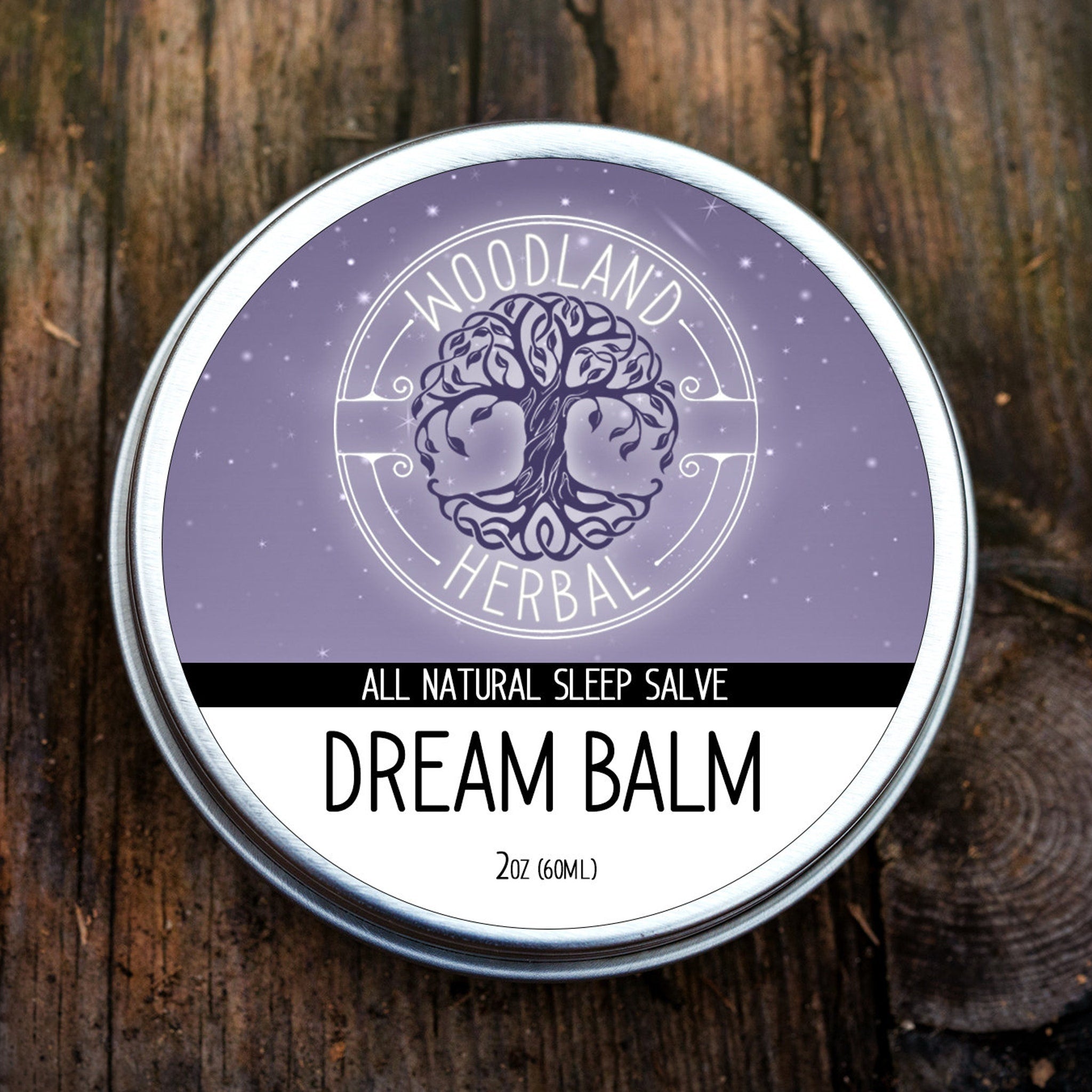 Dream Balm tin with silver rim, purple background, and Woodland Herbal label