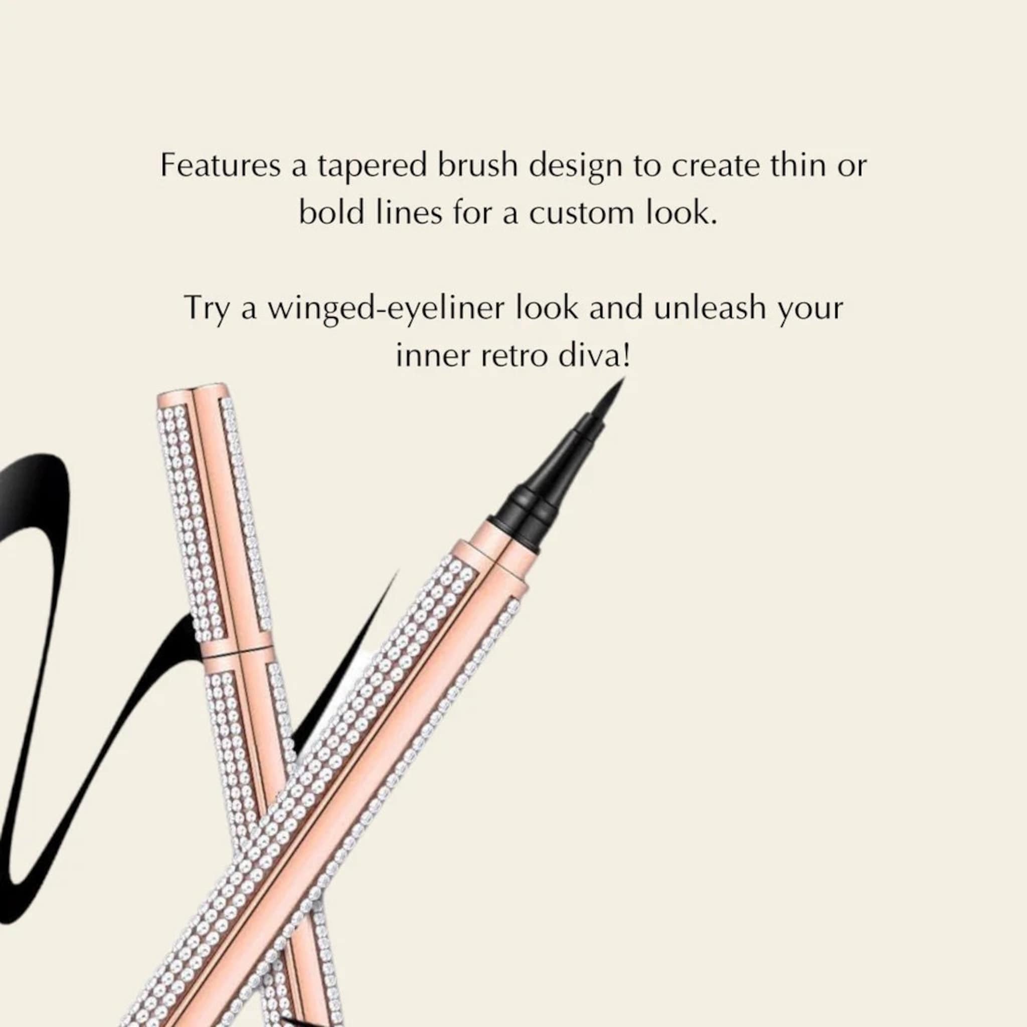 Eyeliner pen with rose gold barrel, rhinestone accents, and black tip for eye makeup