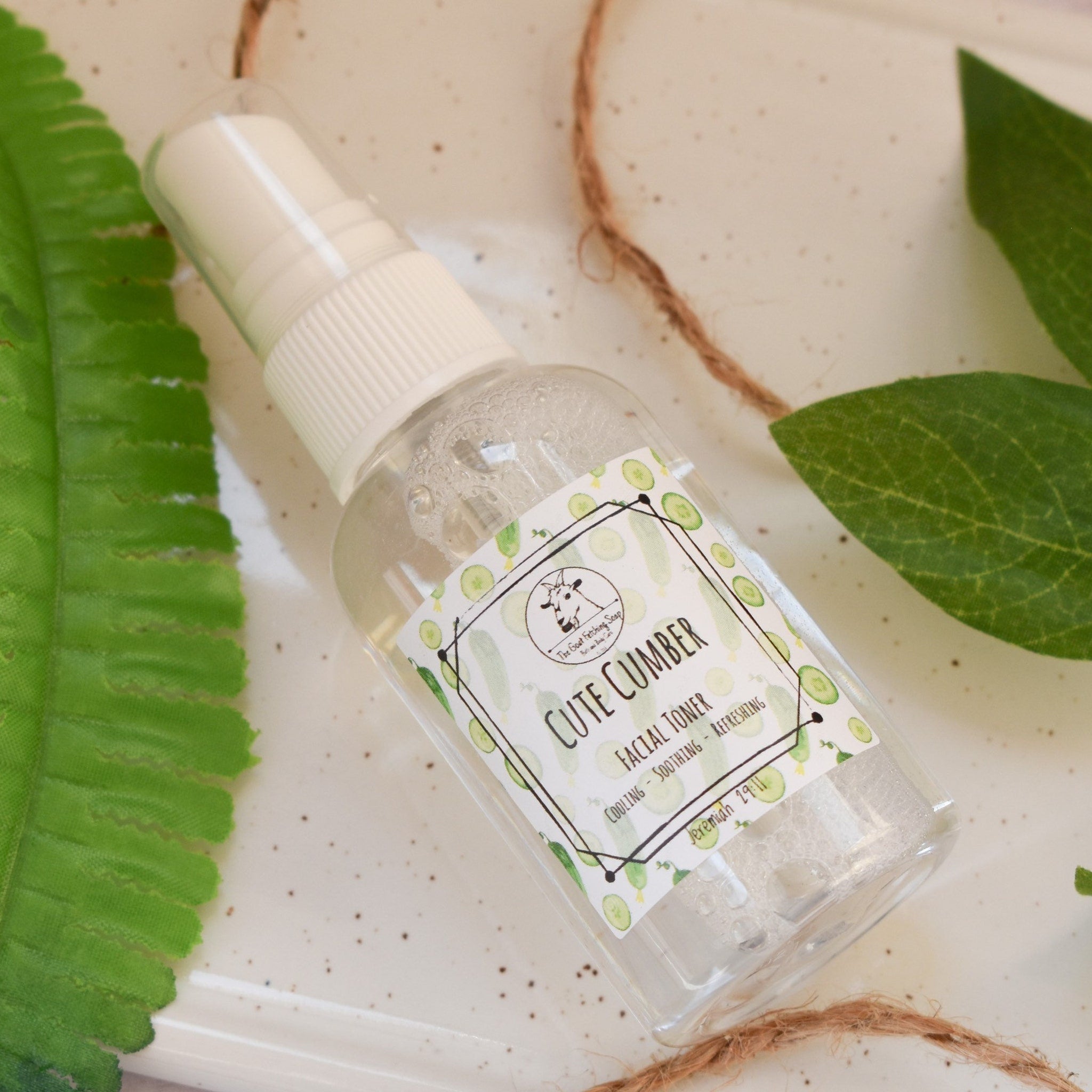 Facial toner bottle with white cap, clear liquid, and "Cute Cumber" label with cucumber pattern