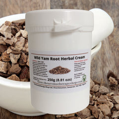 Side view of white wild yam root cream jar with gold lid, showcasing rich herbal texture and minimalist botanical branding