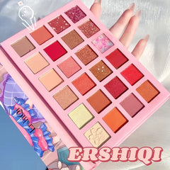 Close-up of 24 vibrant matte and glitter eyeshadow shades in a cartoon-themed palette with waterproof formula