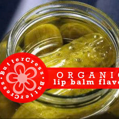 Lip balm flavor oil with green pickles in a glass jar, red banner with Butter Cress text