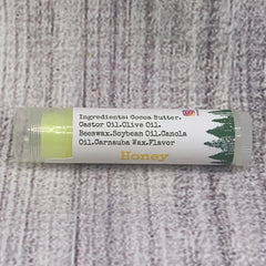 Lip balm tube with yellow balm, white label, and "Honey" text