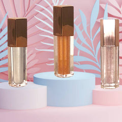 Lip gloss tubes with bronze caps, clear glass, and shimmering liquid contents