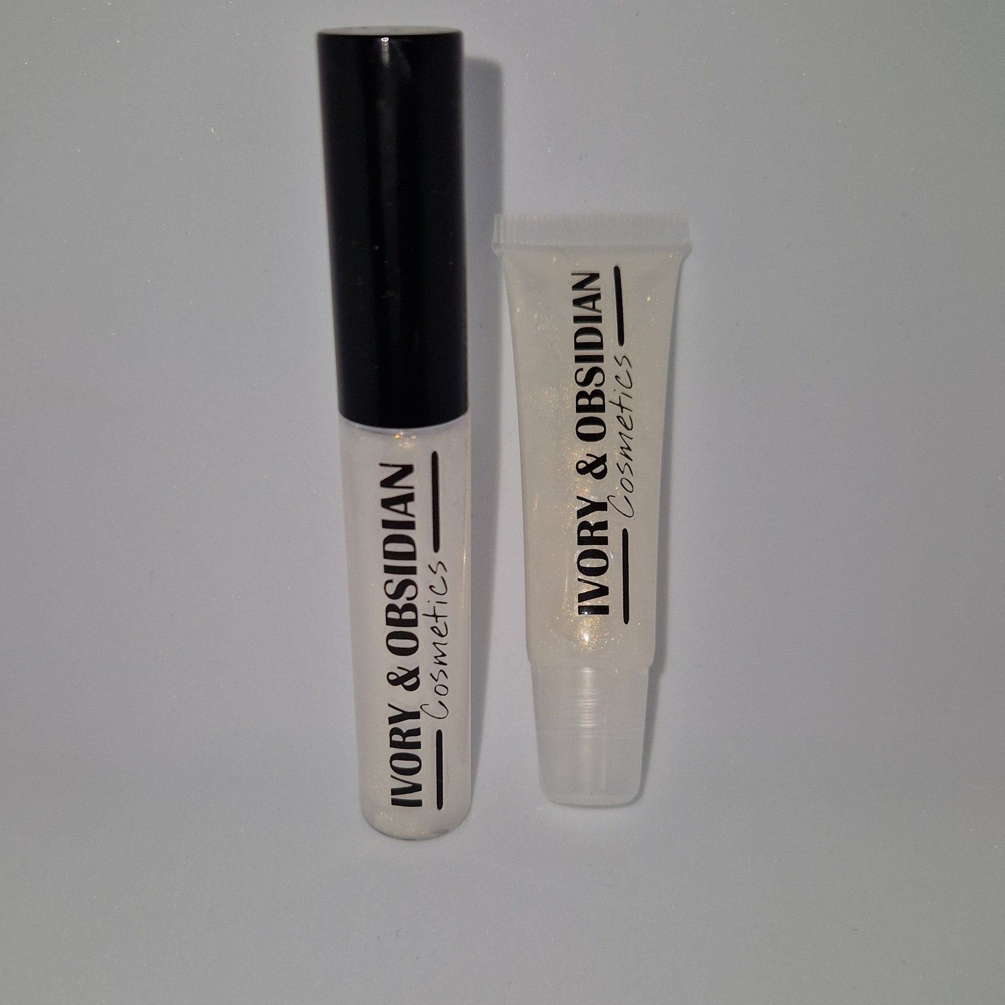 Lip gloss tubes with clear gloss, black cap, and Ivory & Obsidian Cosmetics text