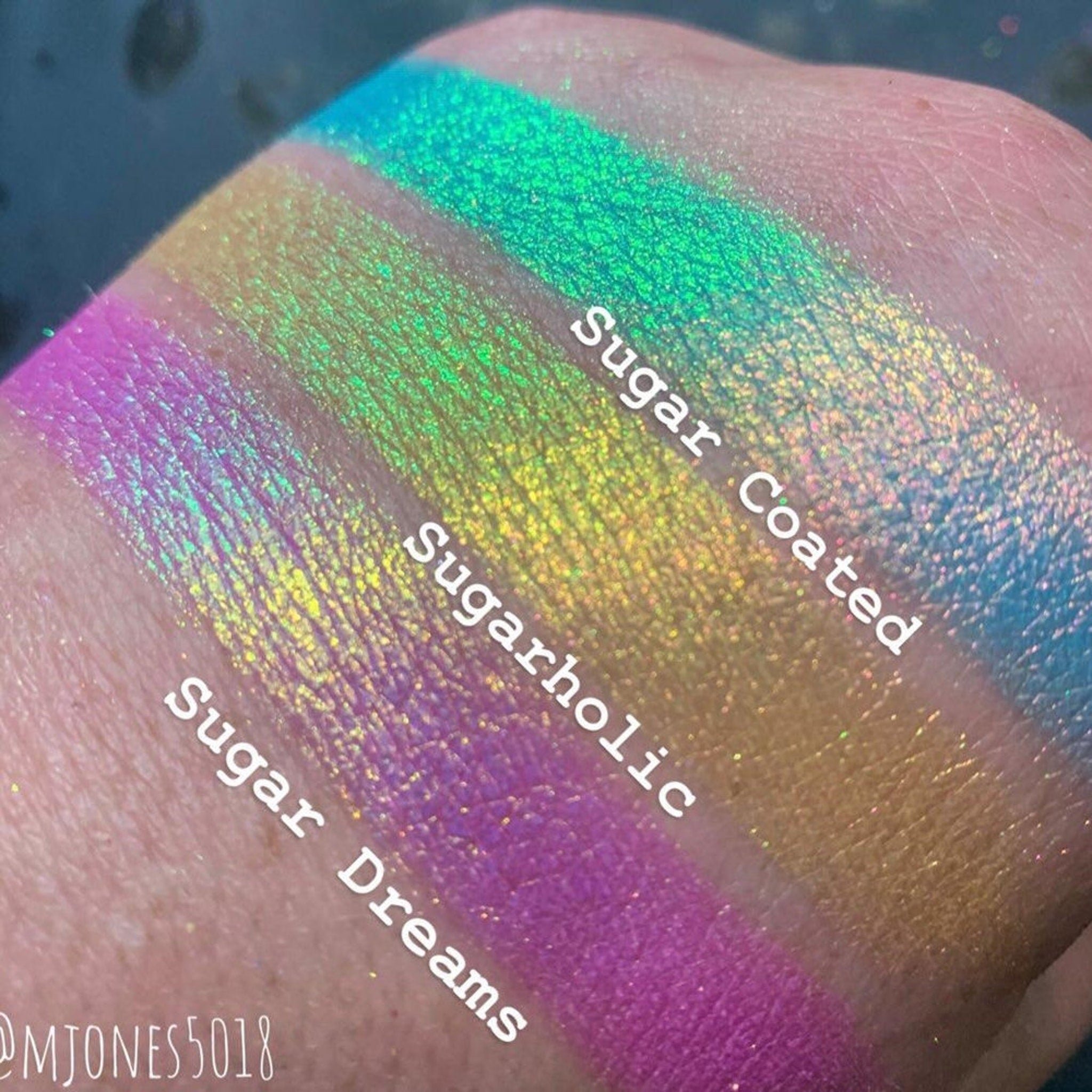 Side view of multichrome eyeshadow palette showing shifting iridescent hues in the Sugar Buzz Collection