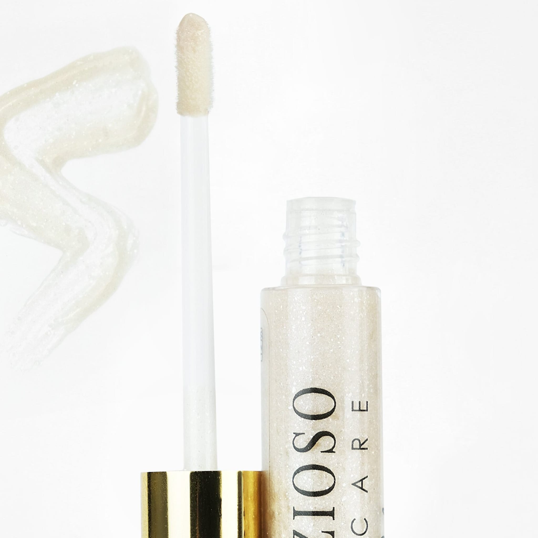 Lip gloss with opal shimmer, applicator, and Delizioso Skincare branding