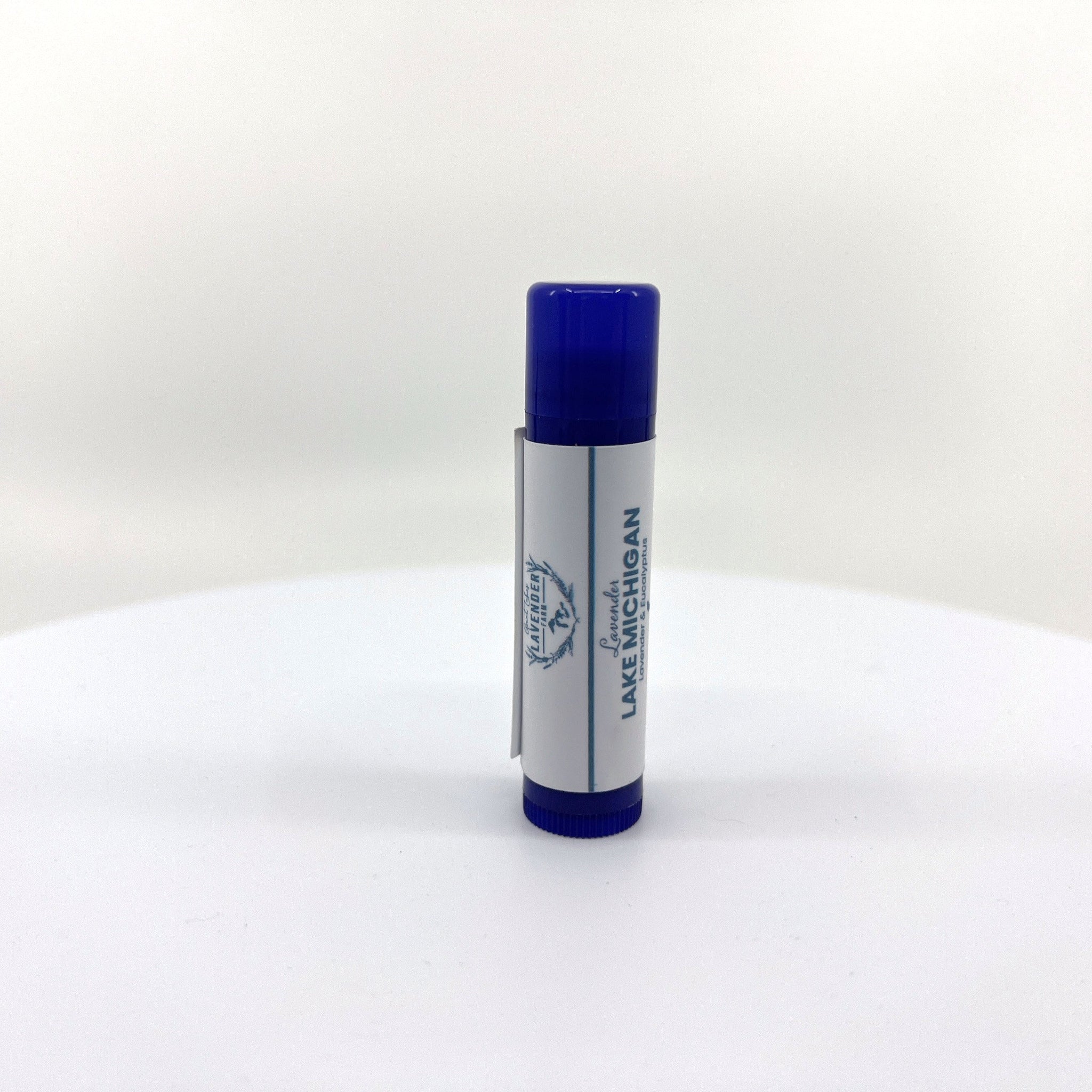 Lip balm tube with blue cap and white label, "Lavender Lake Michigan" text visible