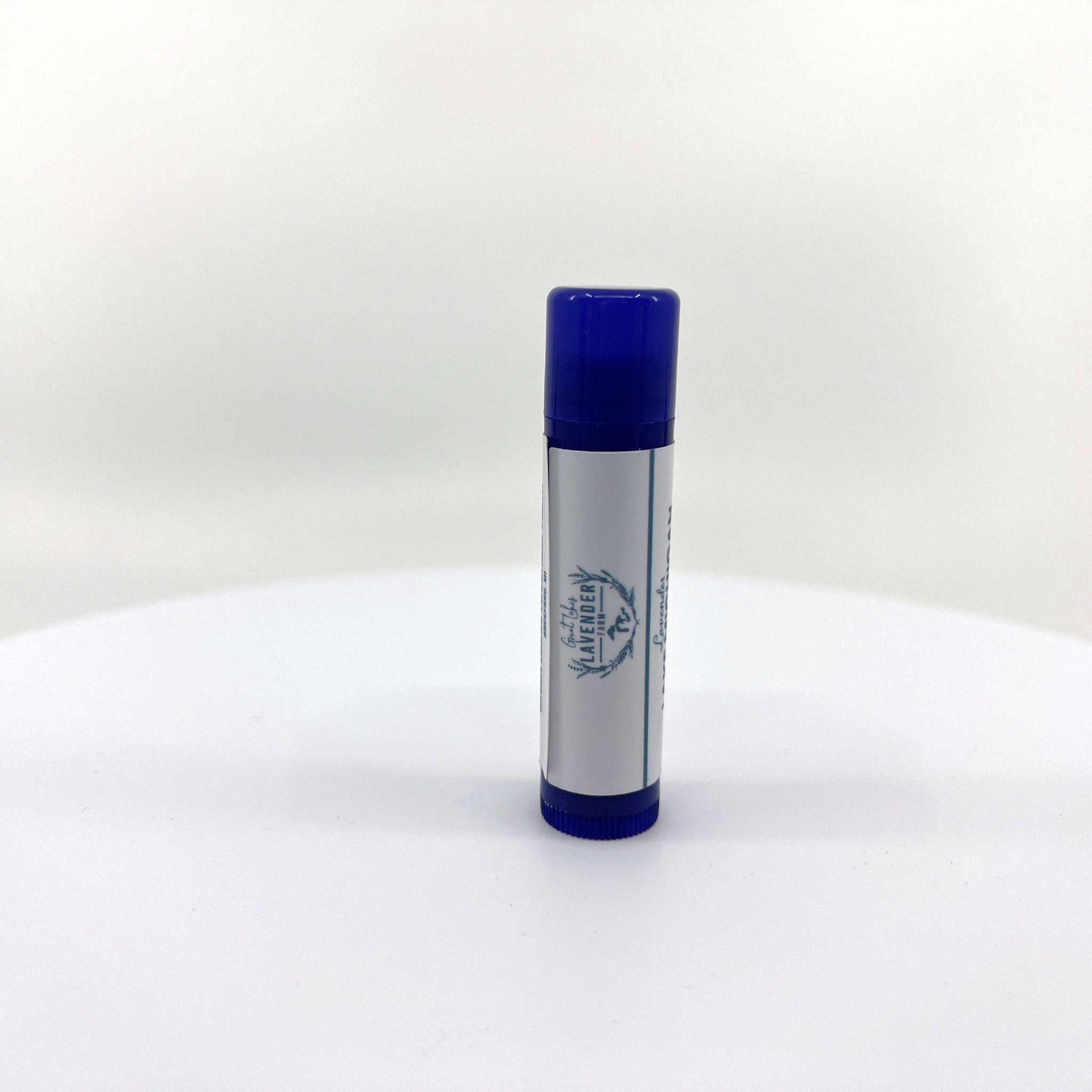 Lip balm tube with blue cap and white label, "Great Lakes Lavender Farm" text visible