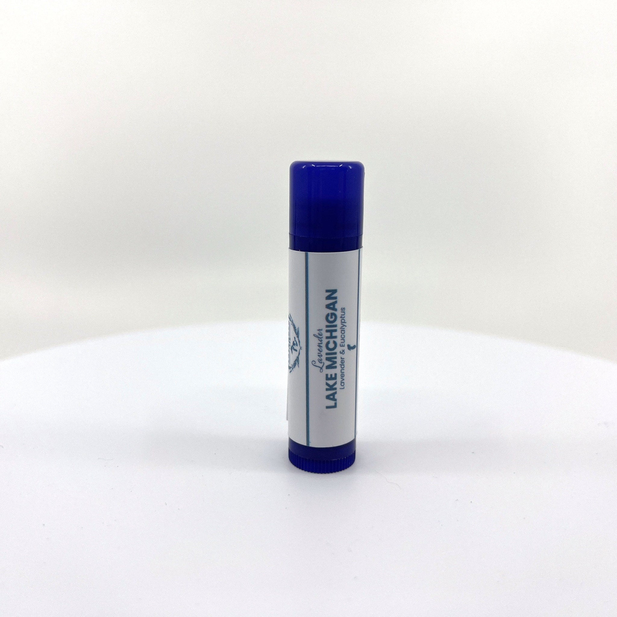 Lip balm tube with blue cap and white label, "Lake Michigan" text visible