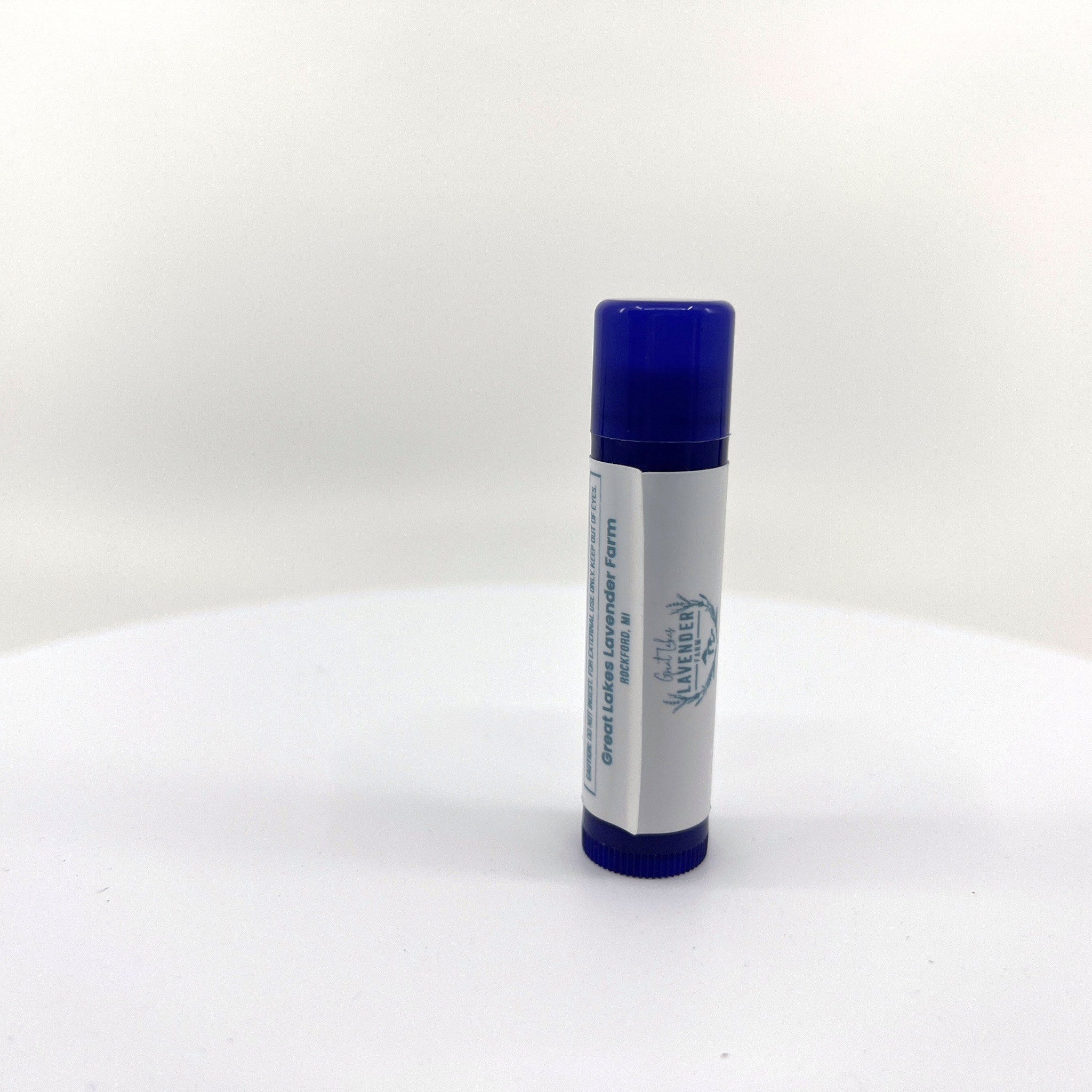 Lip balm with blue cap and white label, Great Lakes Lavender Farm text visible