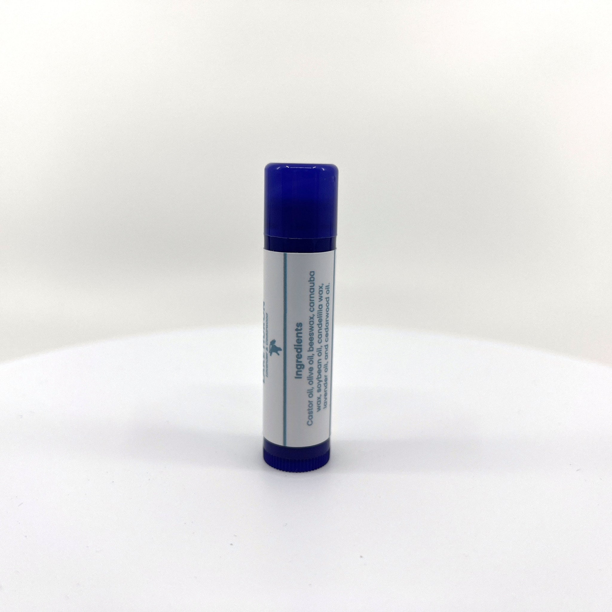 Lip balm tube with blue cap, white label, and visible ingredients list