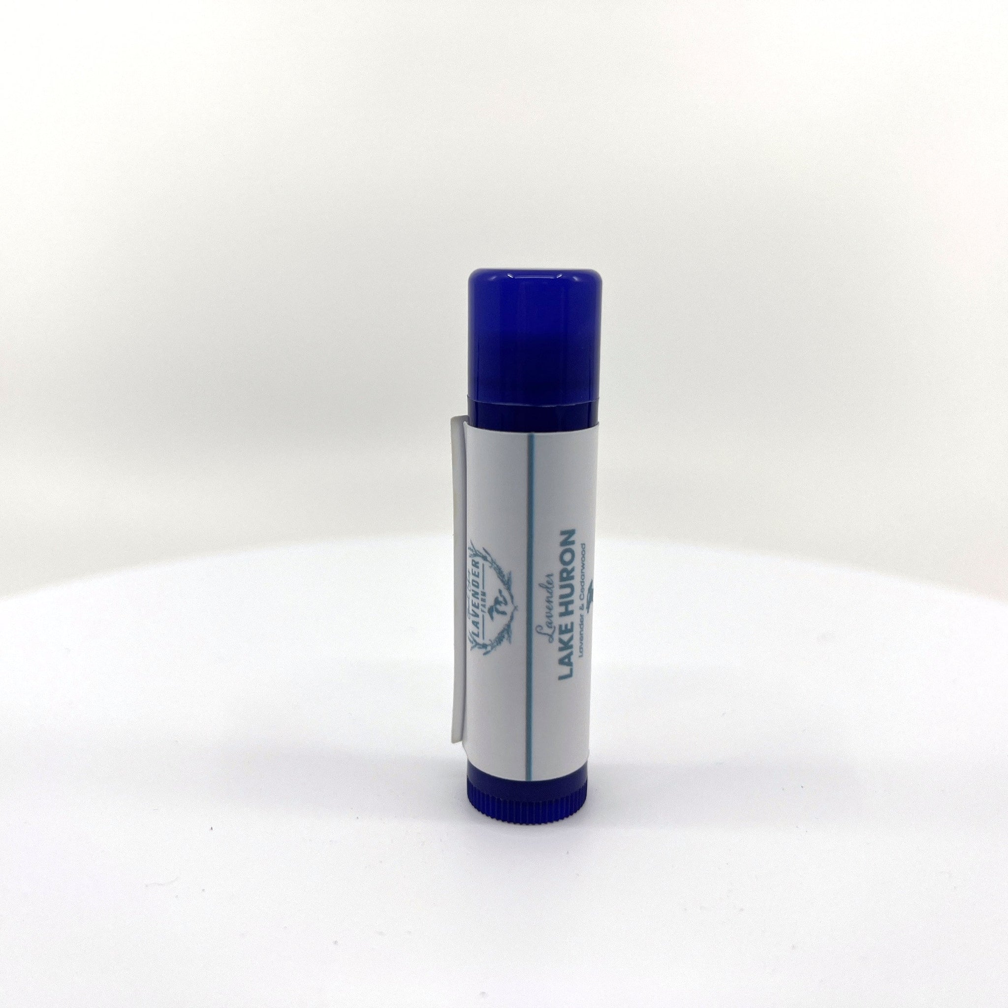 Lip balm tube with blue cap and white label, "Lavender Lake Huron" text visible