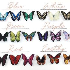 Close-up of white glitter butterfly eyeshadow decals with delicate wing details on clear adhesive backing