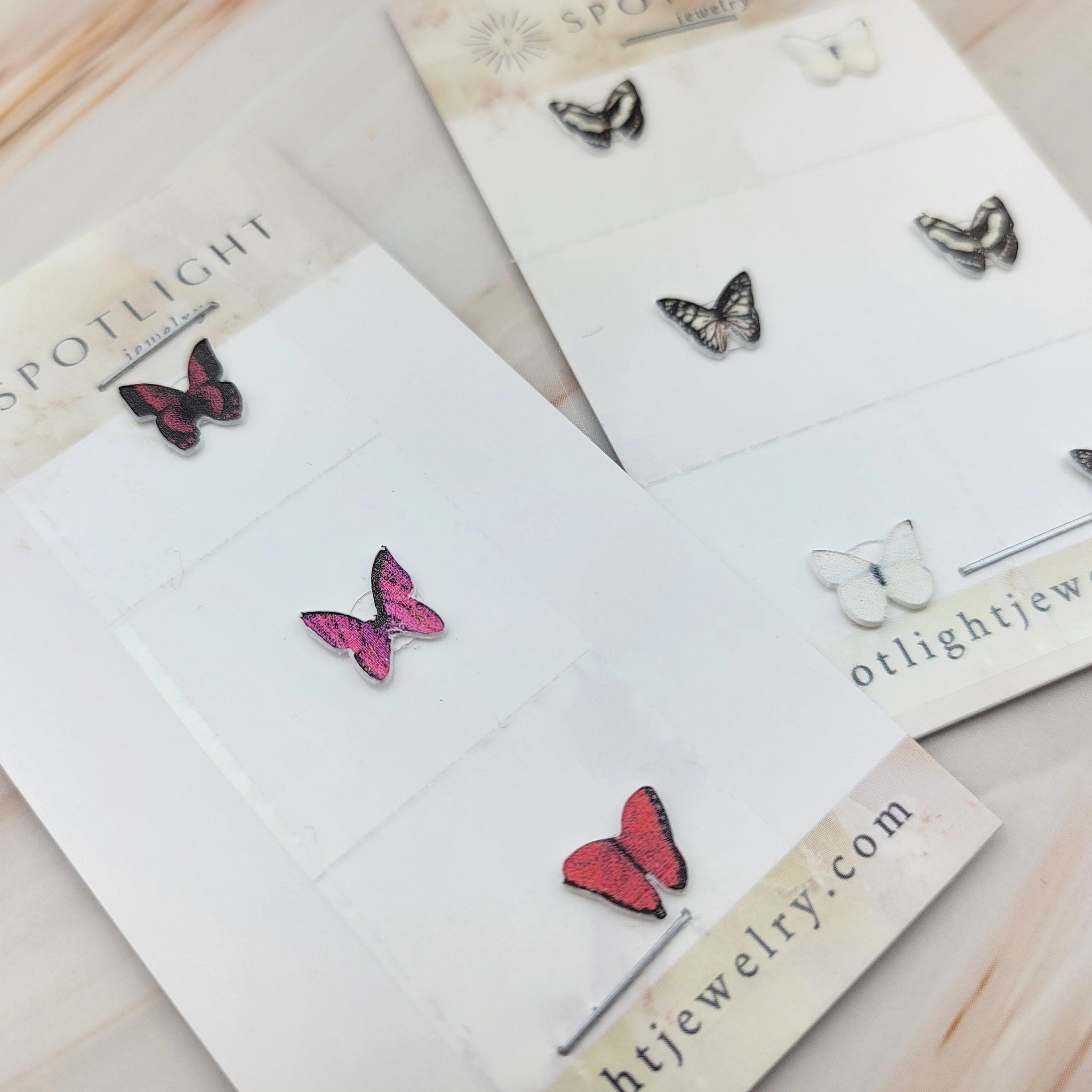 Close-up of white glitter butterfly eyeshadow decal being applied to eyelid with fingertip