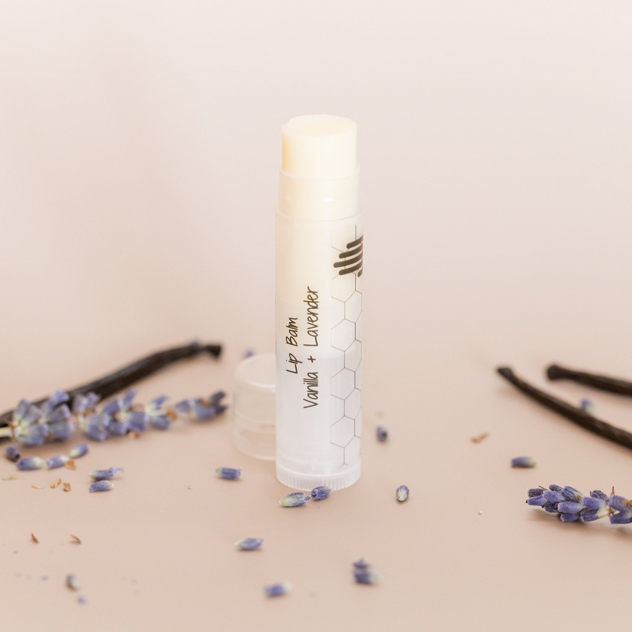 Lip balm tube with white and clear plastic, honeycomb pattern, and HandCraft Skincare text