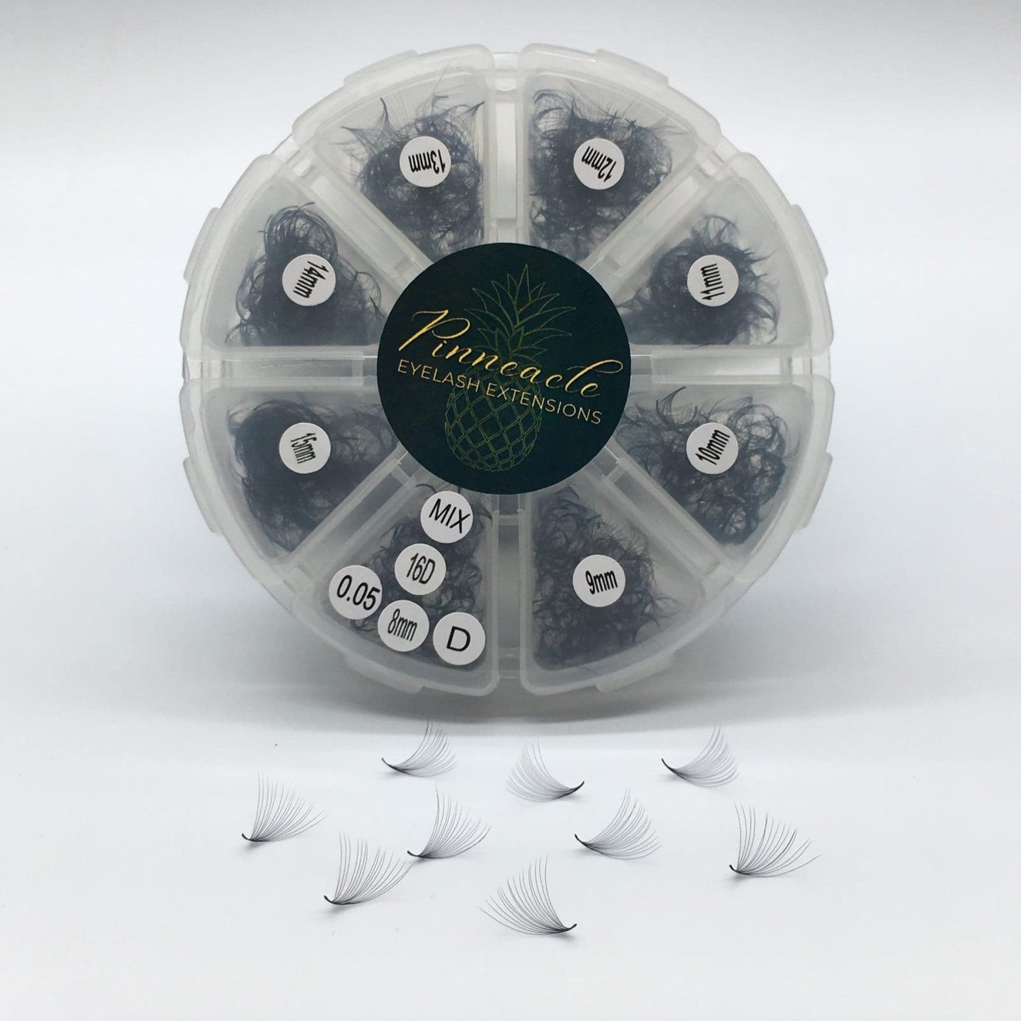Eyelash extensions in black with Pinnacle branding, displayed in a clear plastic organizer, and individual fans