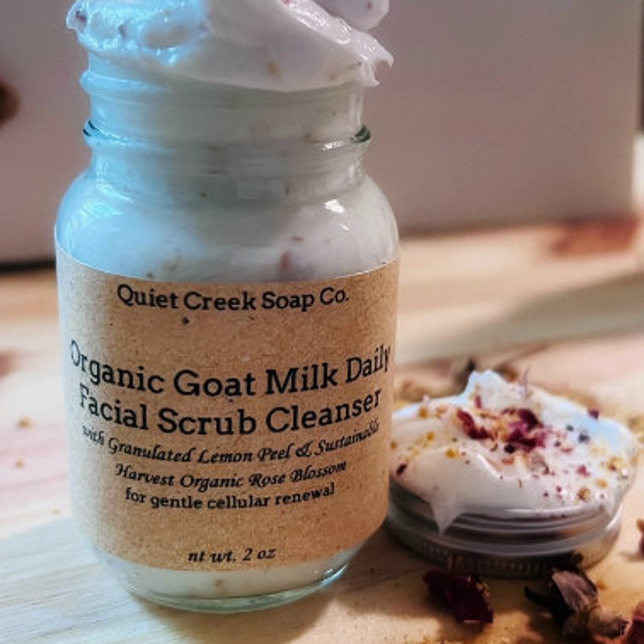 Goat milk facial scrub cleanser in glass jar with white cream and brown label, Quiet Creek Soap Co.