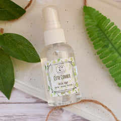 Facial toner bottle, clear glass, white cap, Cute Cumber label, The Goat Fetching Soap brand