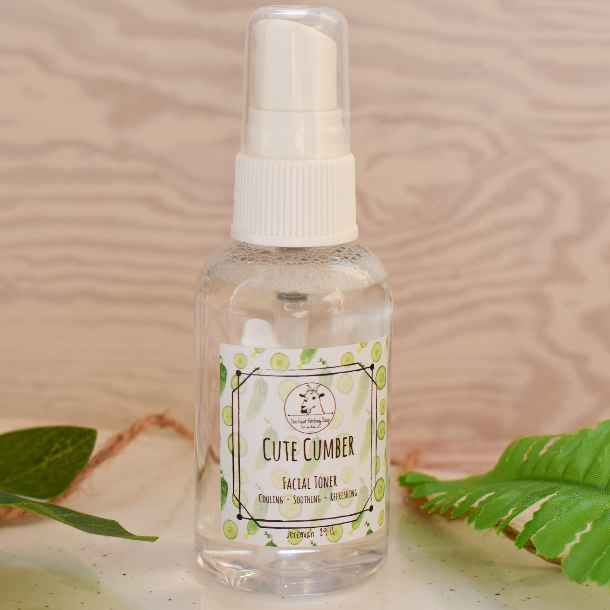 Facial toner bottle with white pump, clear liquid, and "Cute Cumber" label with cucumber design
